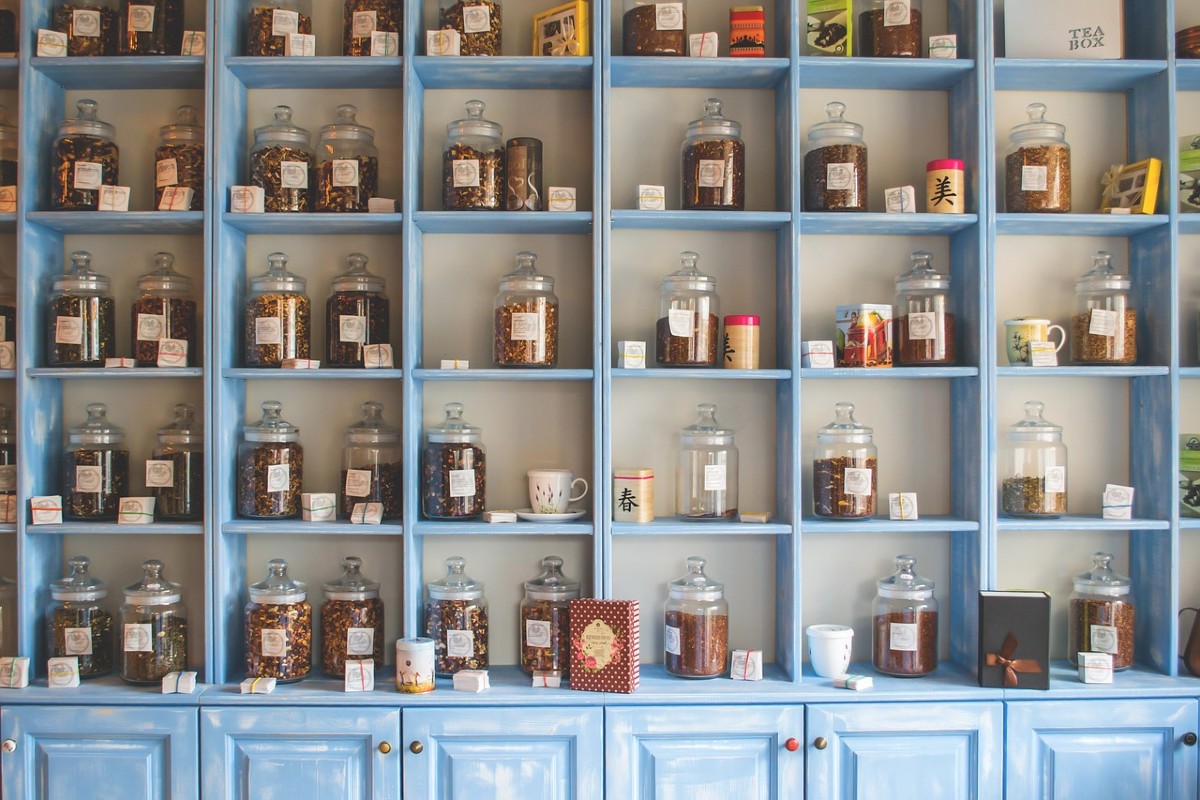 Shelf filled with products inside glass jars 
