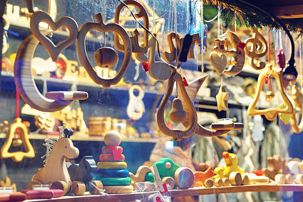 Close-up image of a stand with wooden toys and Christmas tree decorations at the Christmas Market in Old Riga, Latvia